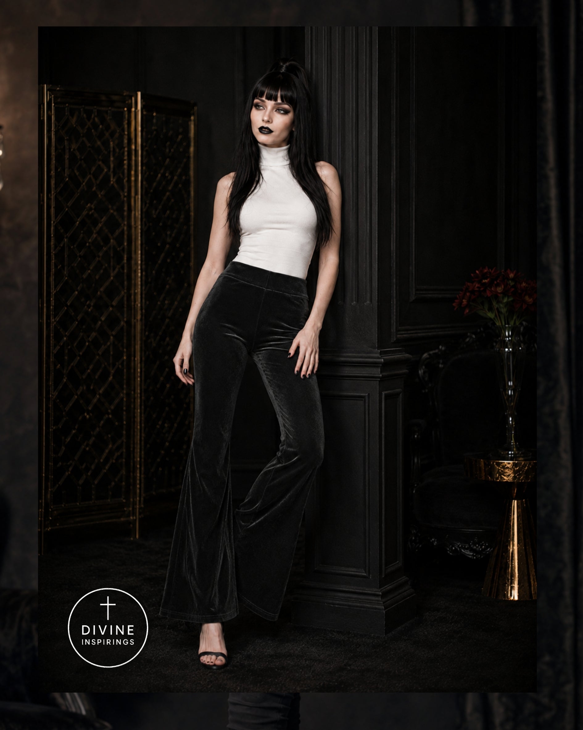 A model with long black hair and dark makeup stands in a dark interior wearing a white sleeveless mock-neck top and black velvet flare pants. A circular 'DIVINE INSPIRINGS' logo is visible in the lower-left corner.