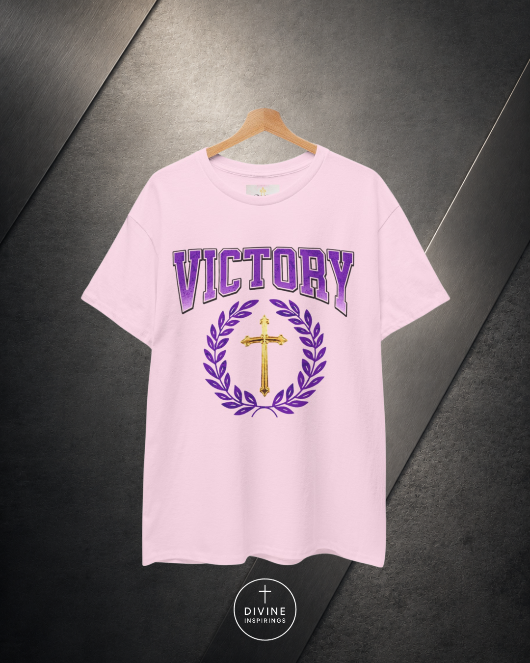 Pink t-shirt with 'Victory' and cross design on a dark background