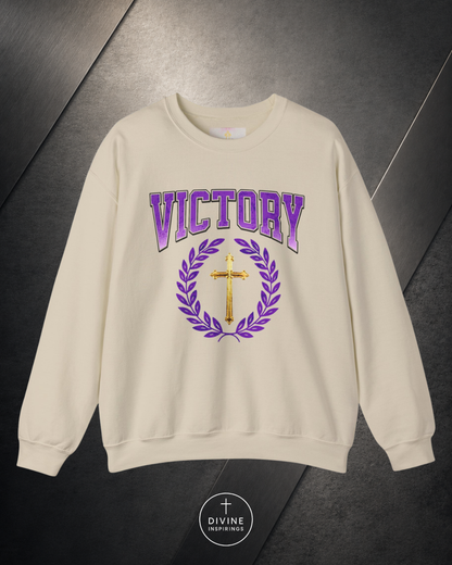Beige sweatshirt with 'VICTORY' text and cross design on a dark background