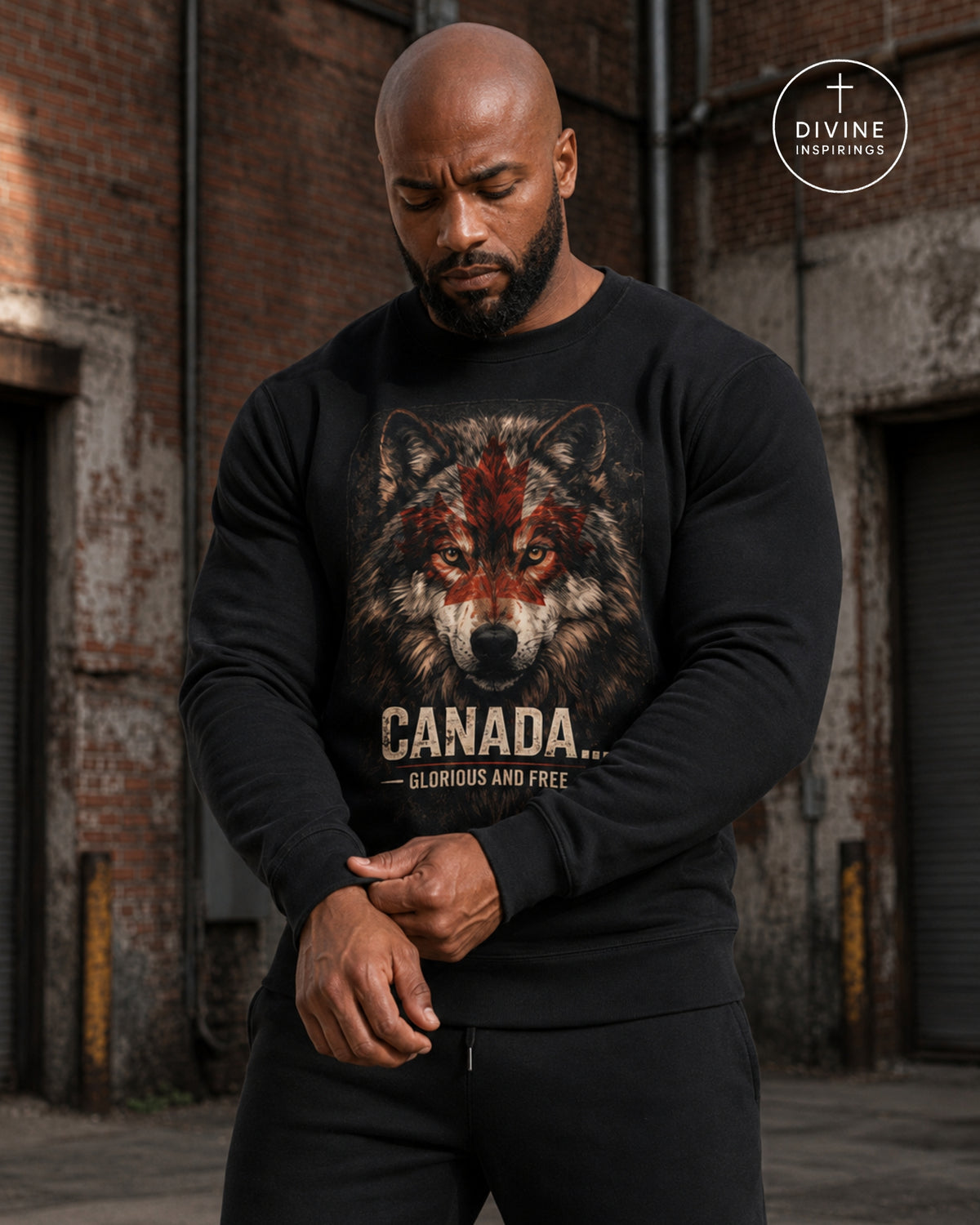 A muscular man wearing a black crewneck sweatshirt with a graphic print of a wolf with red markings and the text 'CANADA.