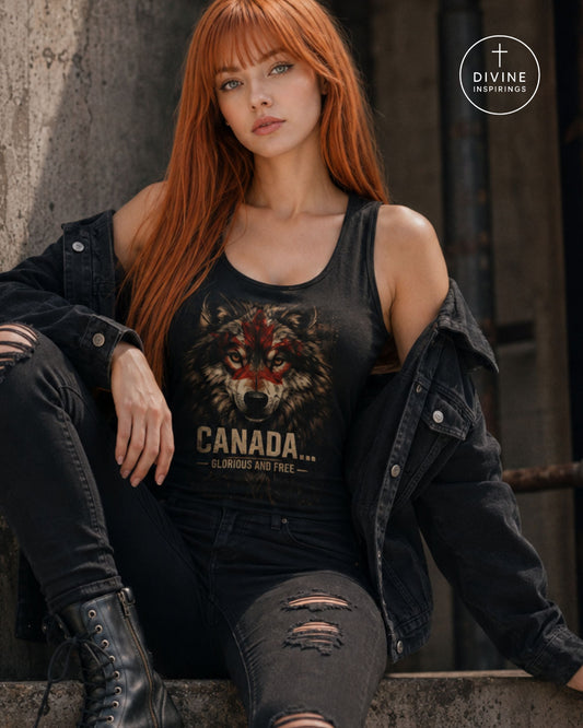 A woman with long red hair sits against a concrete wall wearing a black graphic tank top with a wolf design and the text 'CANADA.