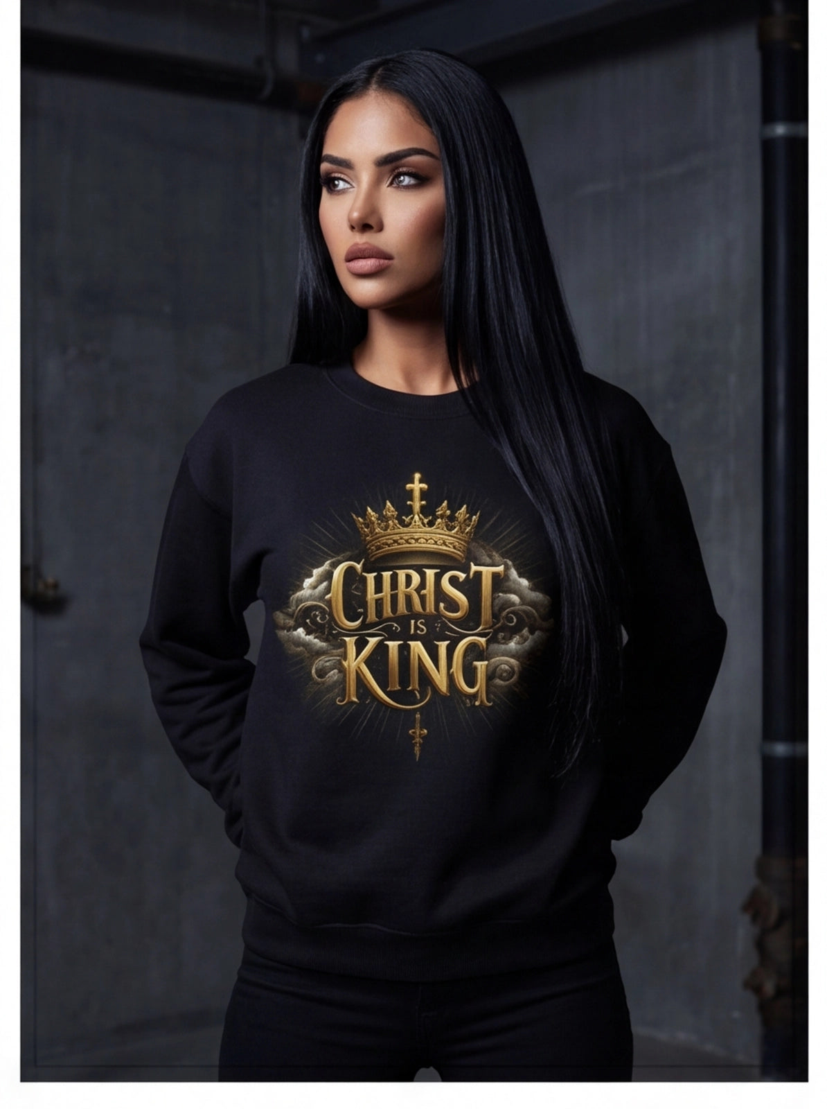 Person wearing a black sweatshirt with 'Christ is King' design against a dark background