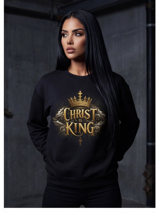 Person wearing a black sweatshirt with 'Christ is King' design against a dark background