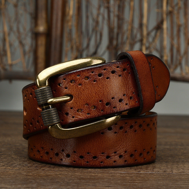Brown leather belt with gold buckle on a wooden surface