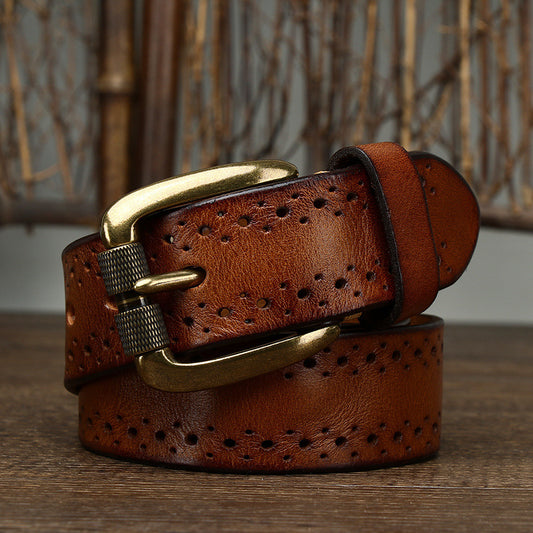 Brown leather belt with gold buckle on a wooden surface