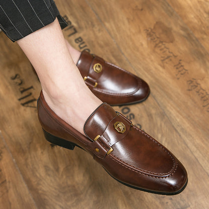Brown leather loafers worn on a wooden floor