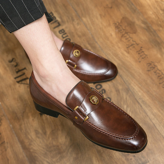 Brown leather loafers worn on a wooden floor