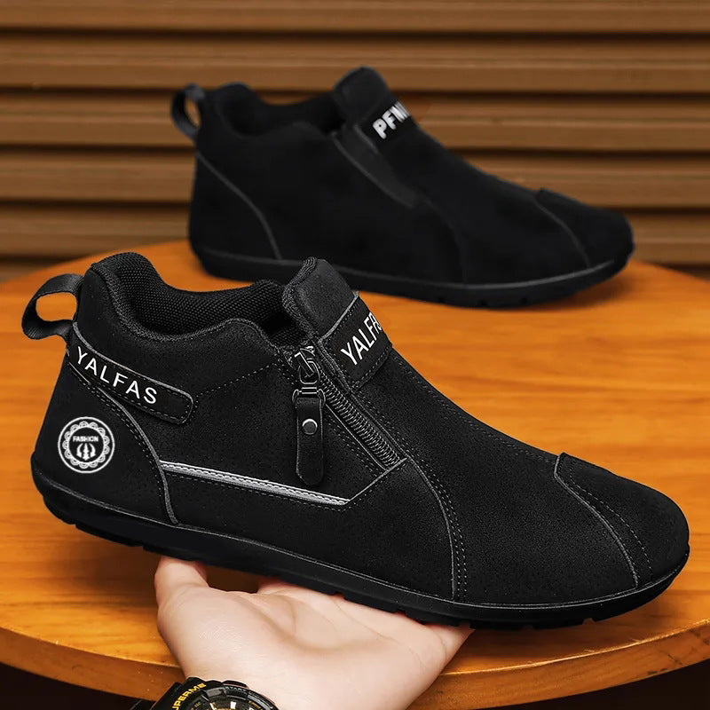 Black ankle boots with visible branding on a wooden surface