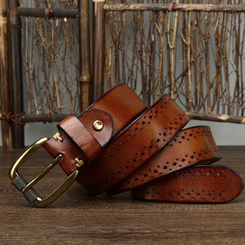 Brown leather belt with gold buckle on a wooden surface