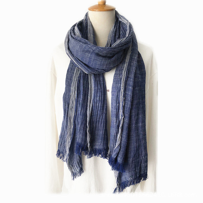 Blue scarf on a mannequin against a white background