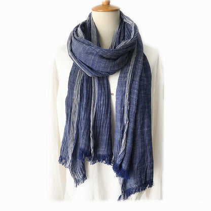 Blue scarf on a mannequin against a white background