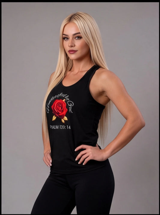 Woman wearing a black tank top with a red rose design on a gray background