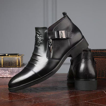 Black leather boots with metal buckles on a wooden surface