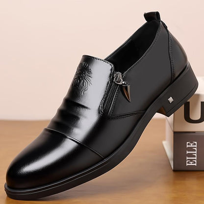 Black leather dress shoe on a wooden surface with a beige background