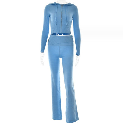 Blue two-piece outfit with a jacket and flared pants on a white background