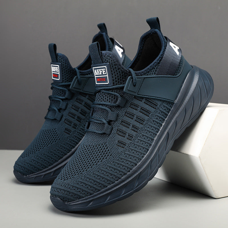 Pair of navy blue sneakers on a gray background