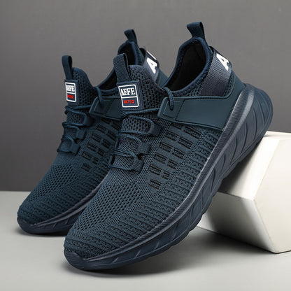 Pair of navy blue sneakers on a gray background