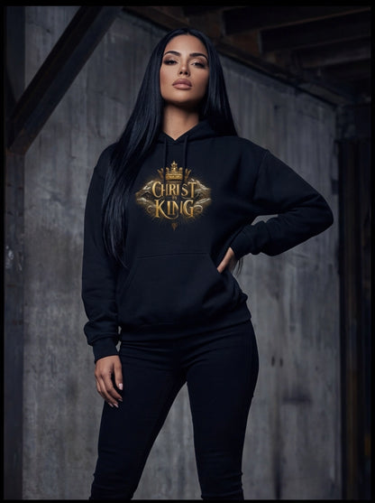 Person wearing a black hoodie with 'Christ King' text in gold, standing against a wooden wall.