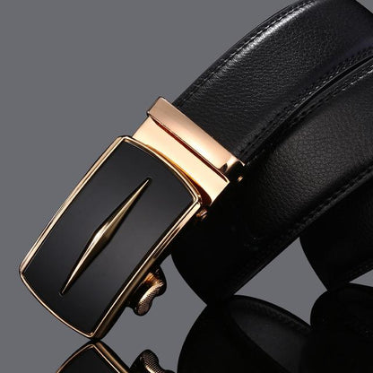 Black leather belt with a gold buckle on a dark background