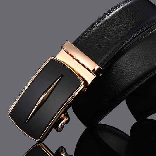 Black leather belt with a gold buckle on a dark background