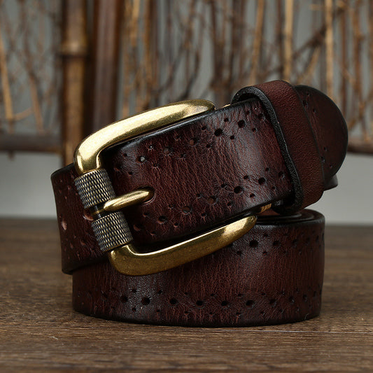 Brown leather belt with gold buckle on a wooden surface
