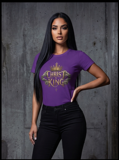 Woman wearing a purple t-shirt with 'Christ King' text against a gray concrete wall.